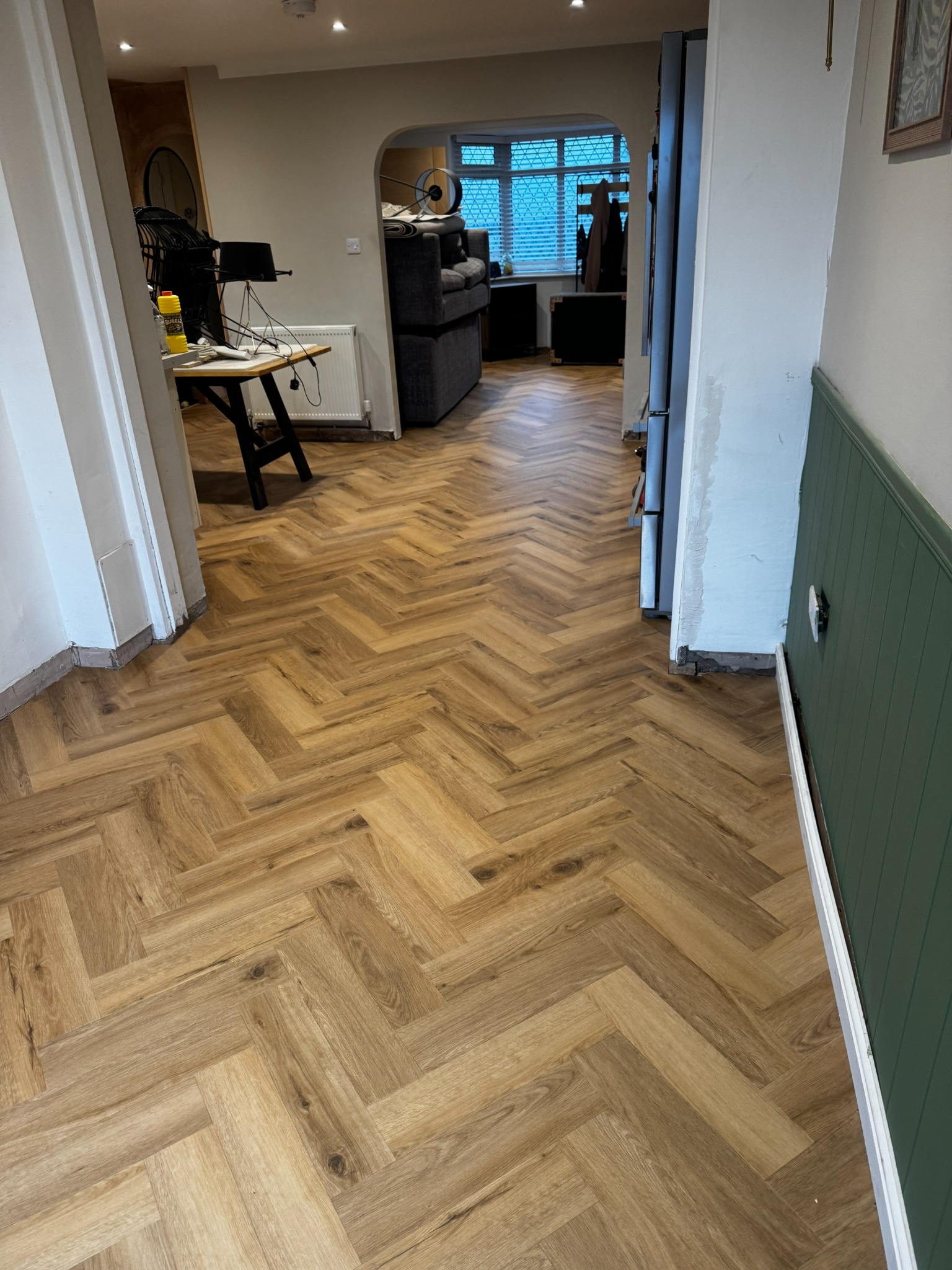 Herringbone LVT flooring through a hallway